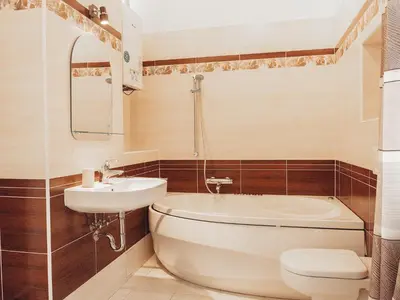a bathroom with a toilet and a sink and a tub at Apartment Art Lounge by Interhome in Prague