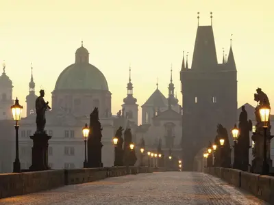 a foggy city with lights and buildings in the background at Apartment Art Lounge by Interhome in Prague
