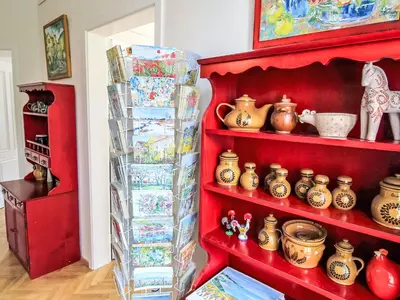 a red shelf with pottery on it in a room at Apartment Art Lounge by Interhome in Prague