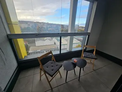 a room with two chairs and a large window at Apartment - O2 Arena Prague with parking in Prague