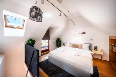 a white bedroom with a large bed and a window at 4BR & 2,5Bath Harry Potter Old TOWN and GREAT patio in Prague