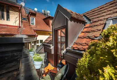 a balcony of a house with potted plants on it at 4BR & 2,5Bath Harry Potter Old TOWN and GREAT patio in Prague