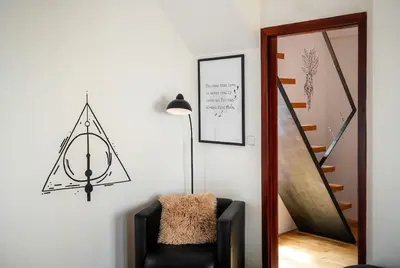 a living room with a chair and a staircase at 4BR & 2,5Bath Harry Potter Old TOWN and GREAT patio in Prague