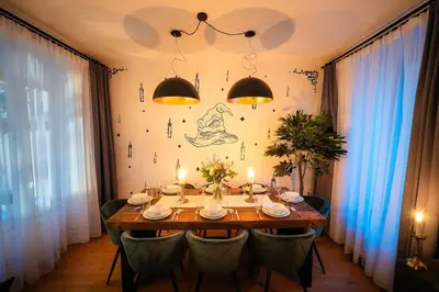 a dining room with a table with chairs and lights at 4BR & 2,5Bath Harry Potter Old TOWN and GREAT patio in Prague
