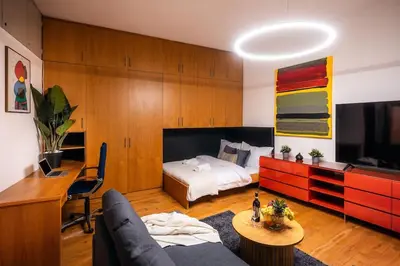 a bedroom with a bed and a desk and a couch at 4BR & 2,5Bath Harry Potter Old TOWN and GREAT patio in Prague