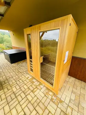 a wooden room with a glass door on a patio at Dolpo 5 in Benešov
