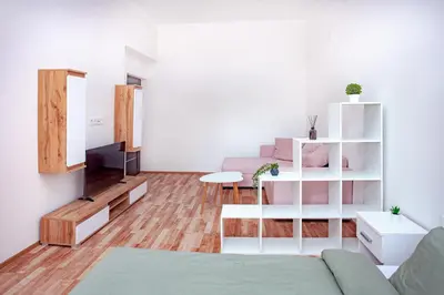 a living room with a couch and a table at Elegance Apartments in Prague