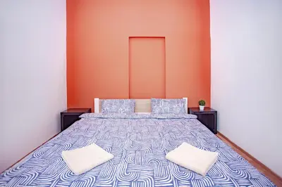 a bedroom with a bed with two pillows at Elegance Apartments in Prague