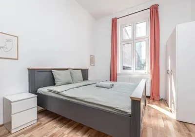 a bedroom with a large bed and a window at Elegance Apartments in Prague