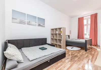 a bedroom with a bed and a desk in it at Elegance Apartments in Prague