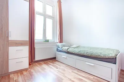 a bedroom with a bed and a window at Elegance Apartments in Prague