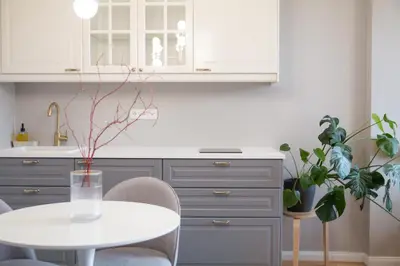 a kitchen with a white table and some plants at Charming Apartment by Wenceslas square and National Museum with AC in Prague