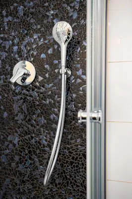 a shower with a shower head on a wall at Charming Apartment by Wenceslas square and National Museum with AC in Prague