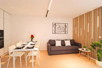 a living room with a table and a couch at The Peony Apartment in Smichov, Prague 5 in Prague