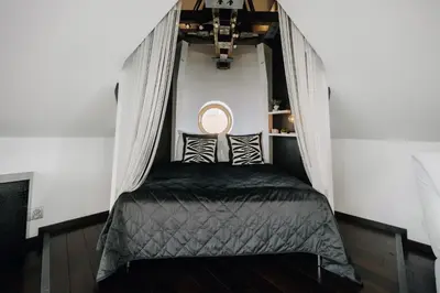 a bed in a room with a window at City View Luxury Apartments with Foosball & Xbox - In City Centre in Prague