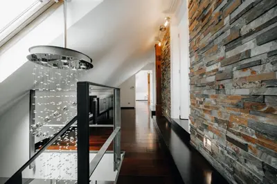 a hallway with a brick wall and a staircase at City View Luxury Apartments with Foosball & Xbox - In City Centre in Prague