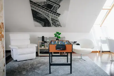 a living room with a table and two chairs at City View Luxury Apartments with Foosball & Xbox - In City Centre in Prague