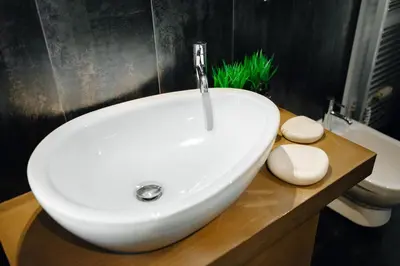 a bathroom with a white sink and a toilet at City View Luxury Apartments with Foosball & Xbox - In City Centre in Prague