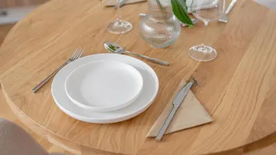 a table with a white plate on a wooden table at Apartment in the Clouds Letná - Luxury with Romantic Balconies in Quiet Centre of Prague in Prague