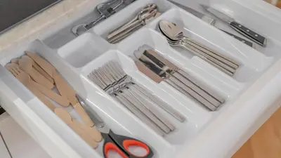 a white drawer with scissors and utensils in it at Apartment in the Clouds Letná - Luxury with Romantic Balconies in Quiet Centre of Prague in Prague