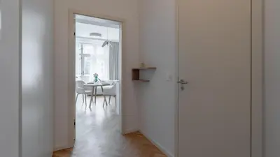a hallway with a door leading to a dining room at Apartment in the Clouds Letná - Luxury with Romantic Balconies in Quiet Centre of Prague in Prague