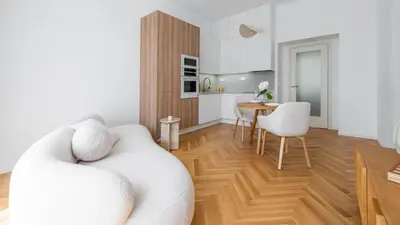 a living room with a white couch and a table at Apartment in the Clouds Letná - Luxury with Romantic Balconies in Quiet Centre of Prague in Prague