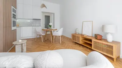 a living room with a bed and a table at Apartment in the Clouds Letná - Luxury with Romantic Balconies in Quiet Centre of Prague in Prague