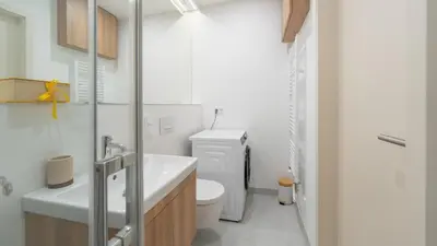 a white bathroom with a toilet and a sink at Apartment in the Clouds Letná - Luxury with Romantic Balconies in Quiet Centre of Prague in Prague