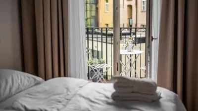 a bedroom with a bed and a view of a balcony at Apartment in the Clouds Letná - Luxury with Romantic Balconies in Quiet Centre of Prague in Prague