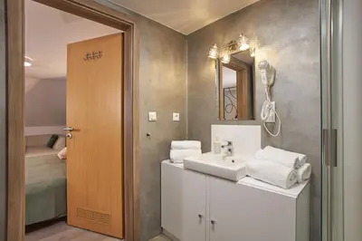 a bathroom with a sink and a mirror at Rybna - Old Town Residence in Prague