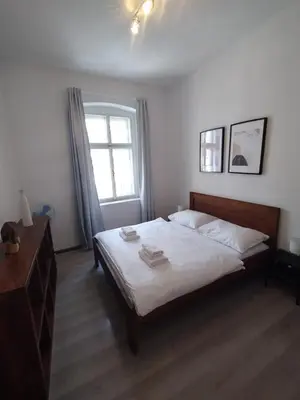 a bedroom with a large bed and a window at Rybna - Old Town Residence in Prague