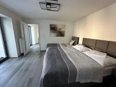 an empty room with a hallway with wooden floors at Apartmány Krymlov in Oleška