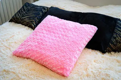 a pink pillow sitting on top of a white blanket at Kingdom of Skylight in Prague
