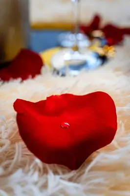 a red heart sitting on top of a white blanket at Kingdom of Skylight in Prague