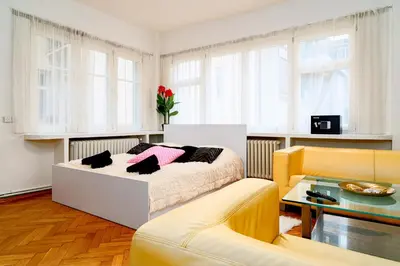 a living room with a bed and a couch at Kingdom of Skylight in Prague