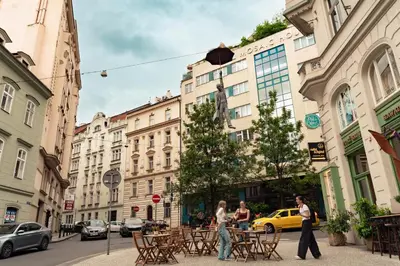 a group of people walking down a city street at Kingdom of Skylight in Prague