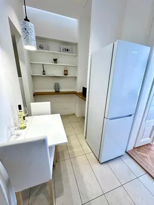 a kitchen with a white refrigerator and a table at Fantastic location! SUPERHOST 5 STAR in Prague