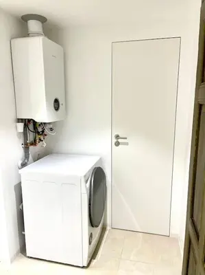 a microwave oven sitting next to a white door at Fantastic location! SUPERHOST 5 STAR in Prague