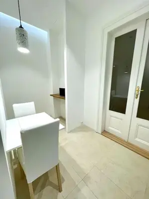 a white room with a table and a chair and a door at Fantastic location! SUPERHOST 5 STAR in Prague