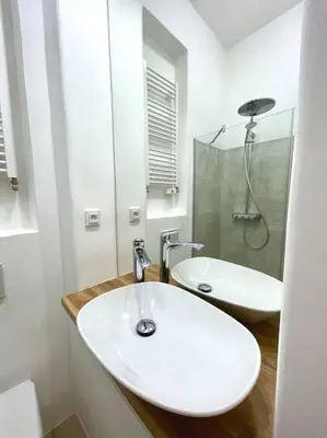 a white bathroom with a sink and a shower at Fantastic location! SUPERHOST 5 STAR in Prague