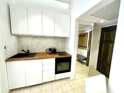 a kitchen with white cabinets and a counter top at Fantastic location! SUPERHOST 5 STAR in Prague