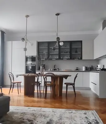a kitchen with a wooden table and chairs at Spacious Apartment in Central Prague 3 bedrooms, 6 people in Prague