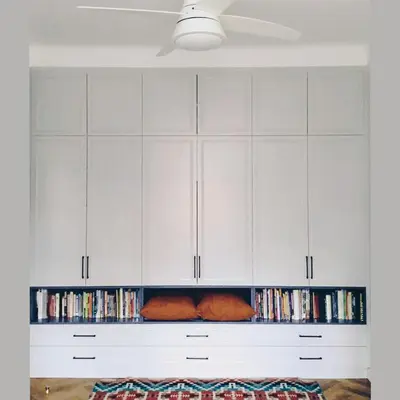 a living room with white cabinets and dvds at Spacious Apartment in Central Prague 3 bedrooms, 6 people in Prague