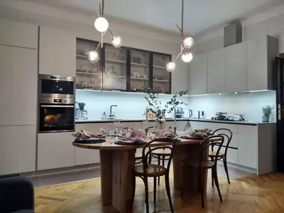 a kitchen with a wooden table and chairs in a kitchen at Spacious Apartment in Central Prague 3 bedrooms, 6 people in Prague
