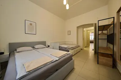 a bedroom with a large bed and a mirror at T&T Homestay in Prague