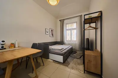 a living room with a bed and a table at T&T Homestay in Prague