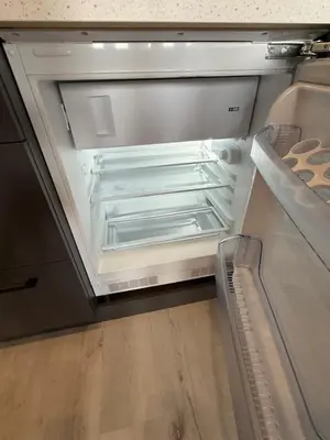 an empty refrigerator with its door open in a kitchen at IOS ArtPrg in Prague