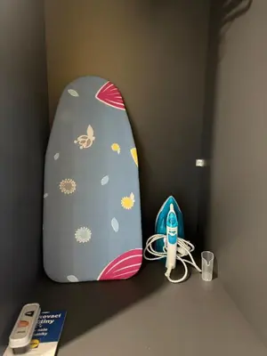 a surfboard is leaned up against a wall at IOS ArtPrg in Prague