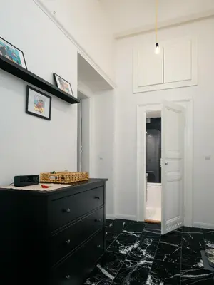 a room with a black dresser and a white wall at Comfortable and cosy apt a few steps from Dancing House and Naplavka Dance in Prague