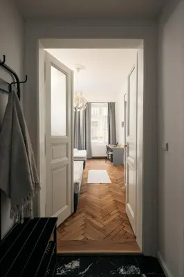 a hallway with an open door to a living room at Comfortable and cosy apt a few steps from Dancing House and Naplavka Dance in Prague